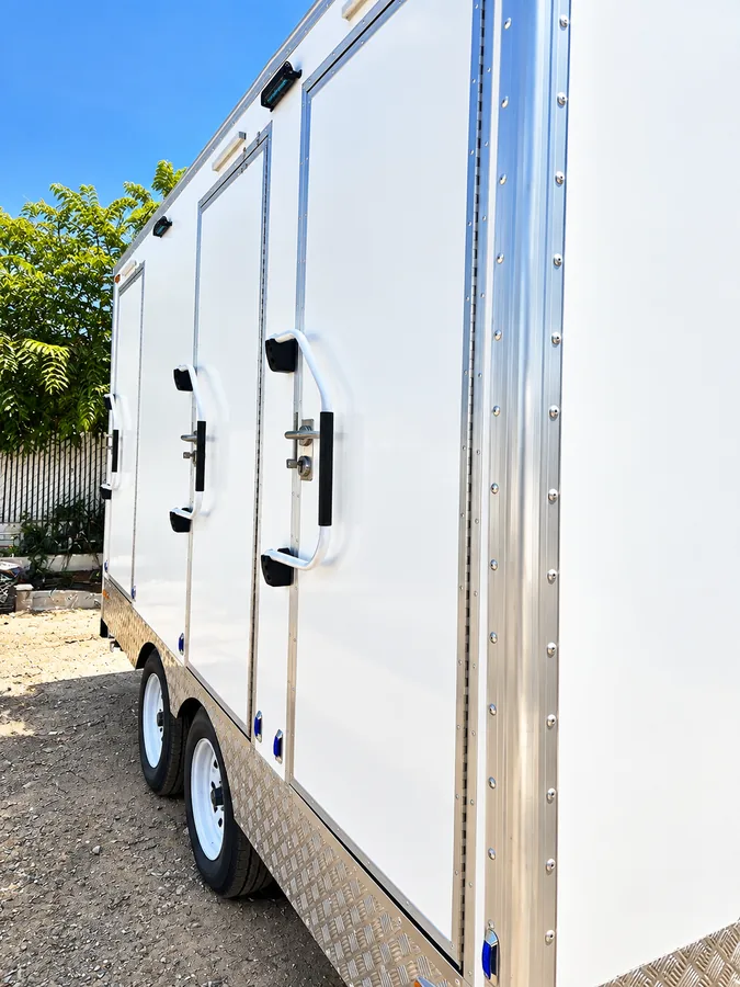 Two exterior doors on a shower and restroom trailer
