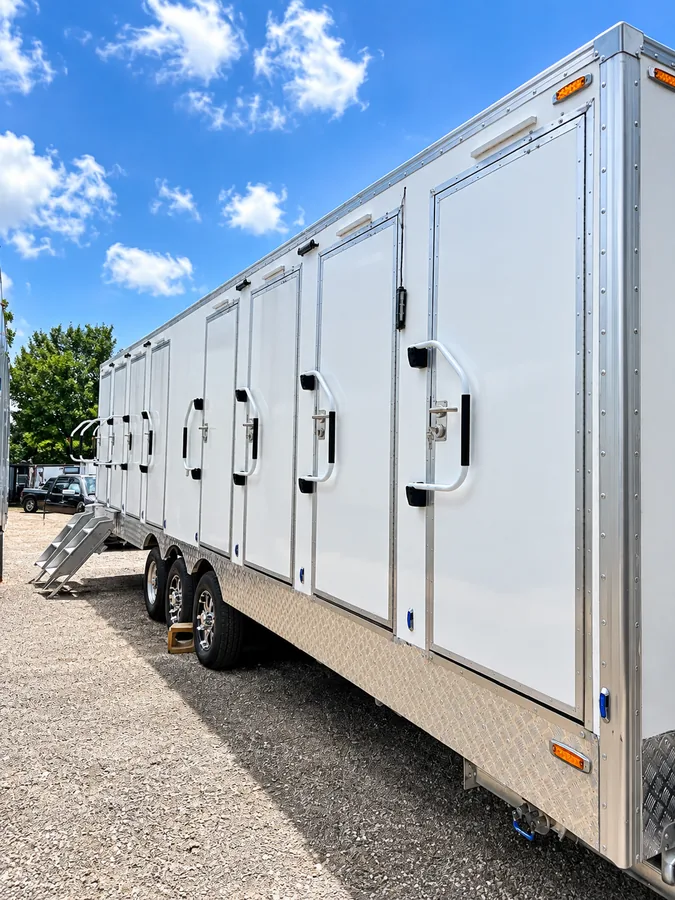 Side view of a long shower and restroom combination trailer