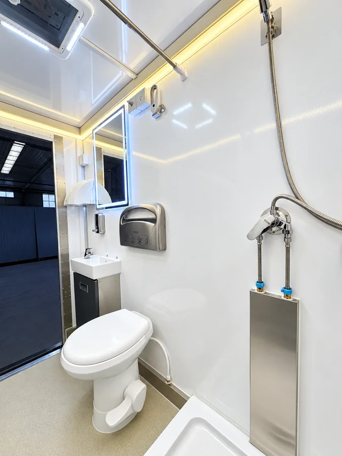 Larger shower and restroom room with grab bars