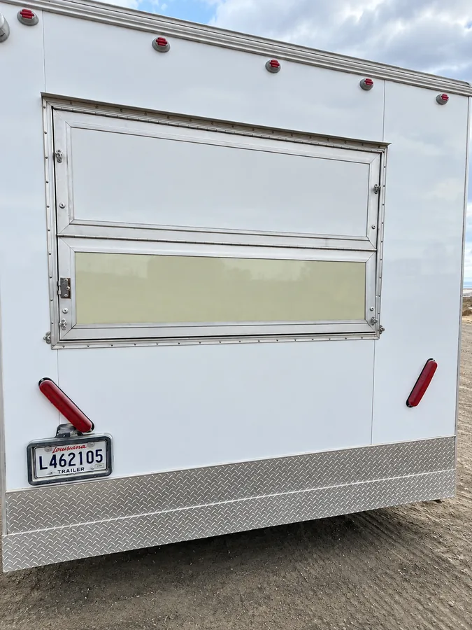 White mobile kitchen trailer with side service window