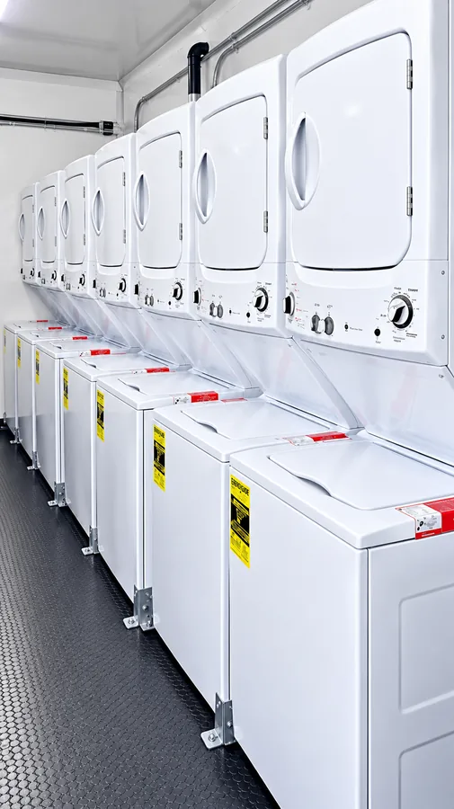 Row of washers and dryers in a mobile laundry trailer