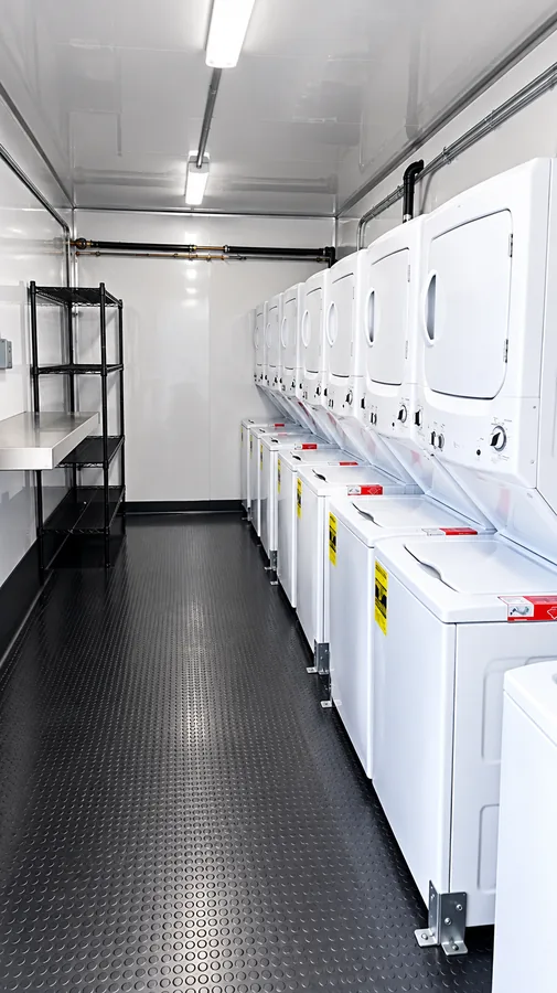 Washers and dryers inside a mobile laundry trailer