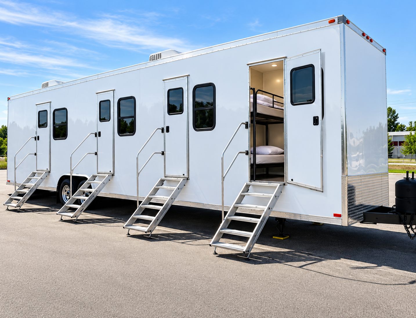 White multi-door sleeping trailer with steps and an open bunk room