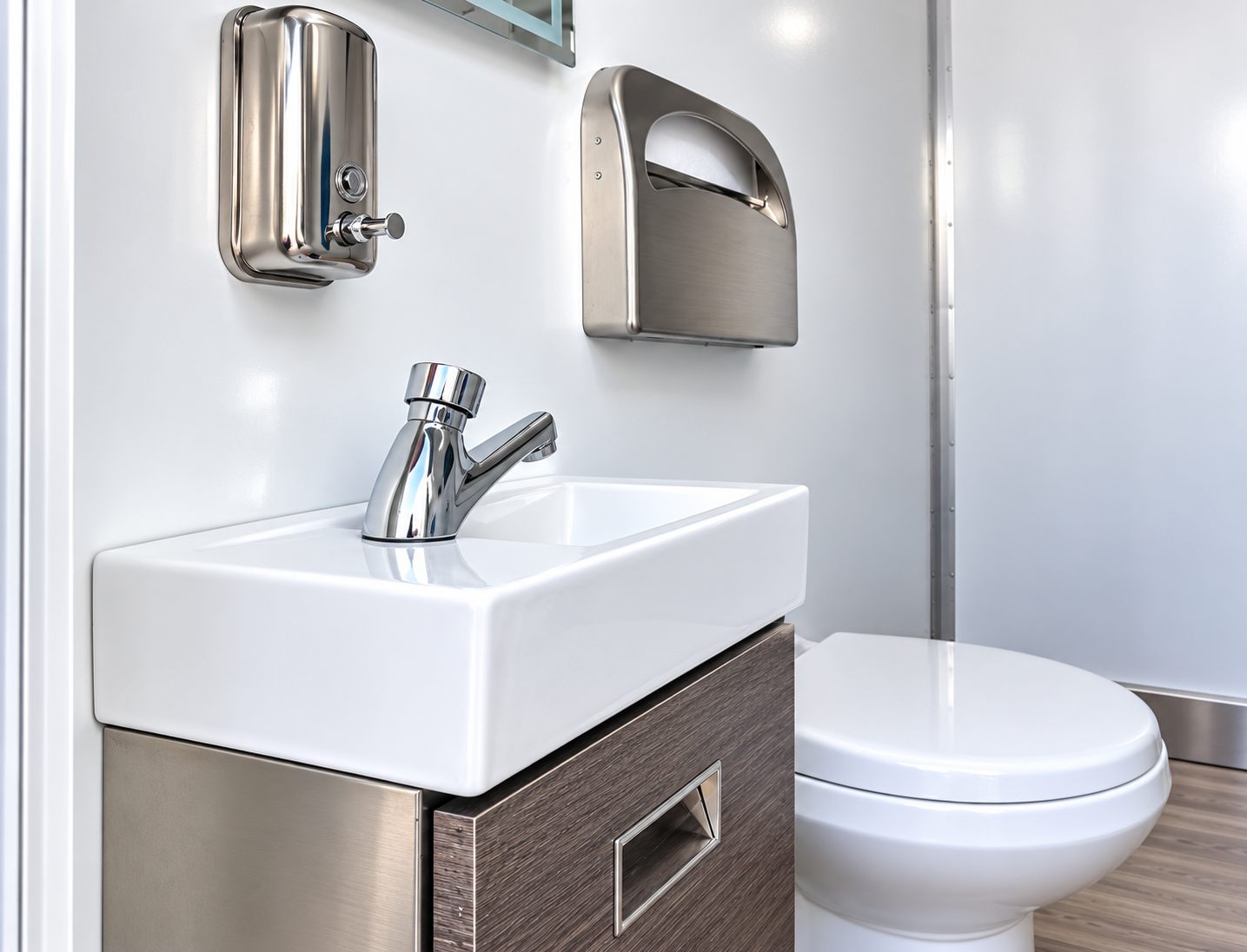 Close view of a handwashing sink beside a toilet