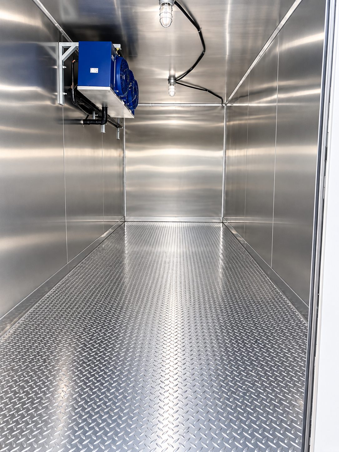 Stainless cold storage room with a visible cooling unit