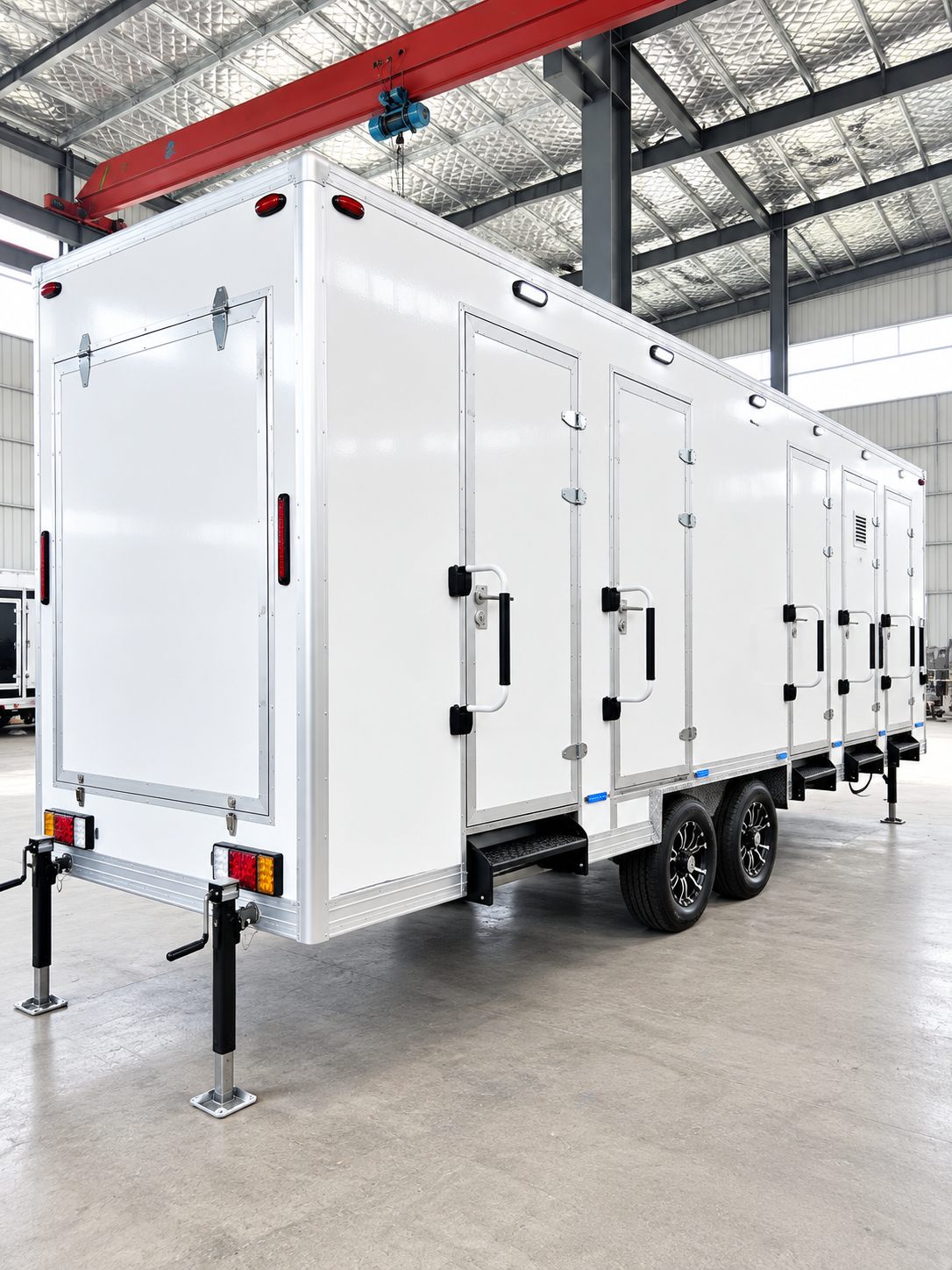 White multi-door trailer staged inside a workshop